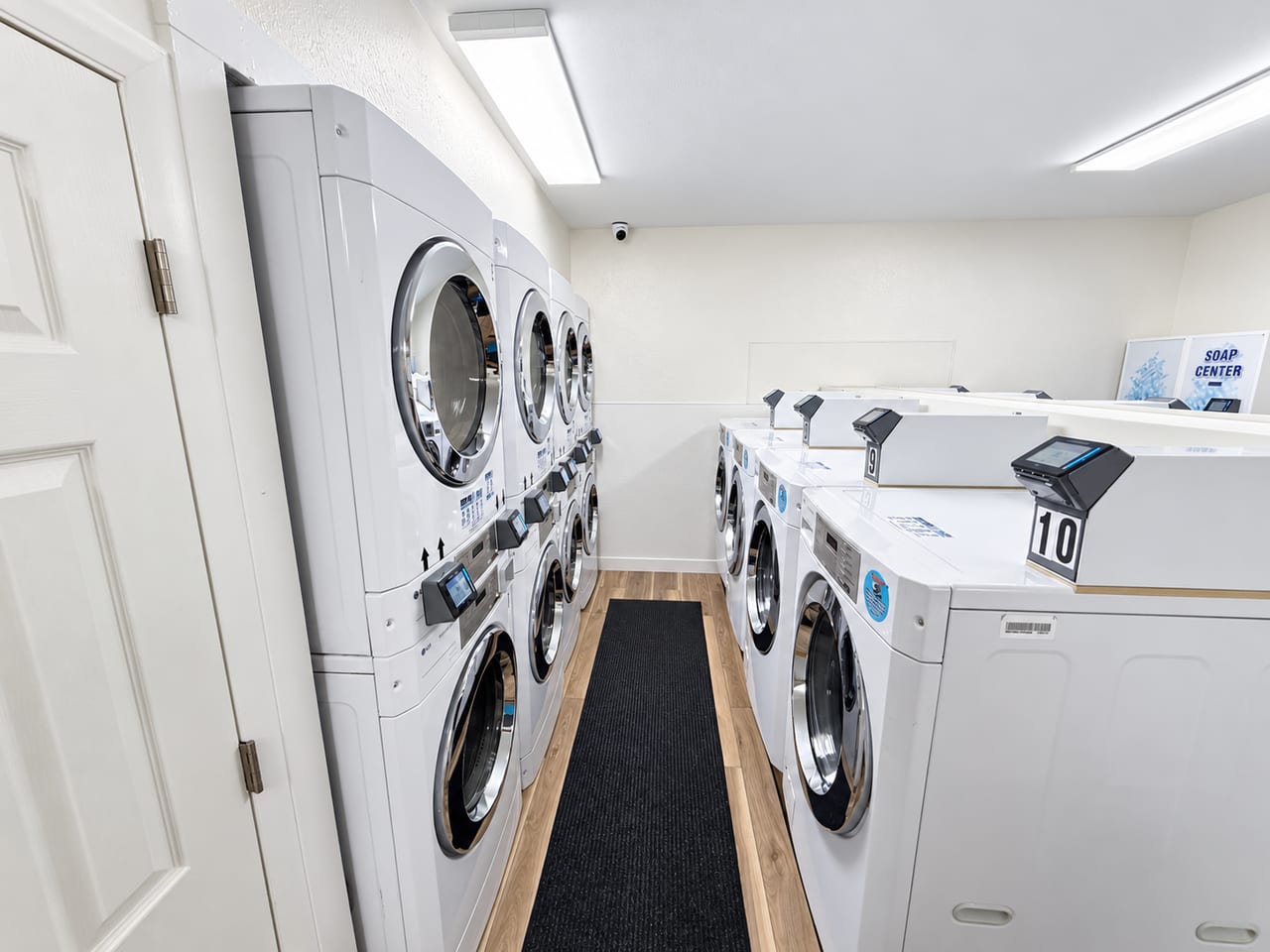 Seven Springs Laundry Facility with stacked dryers on the left and washers and payment readers on the right